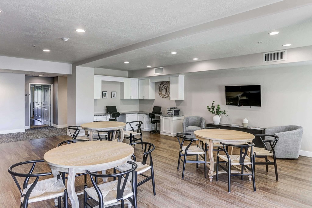 a common area with tables and chairs and a kitchen in the background at The Beckstead, Utah, 84095