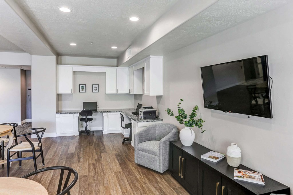 a living room with a tv and a kitchen in the background at The Beckstead, South Jordan, UT, 84095