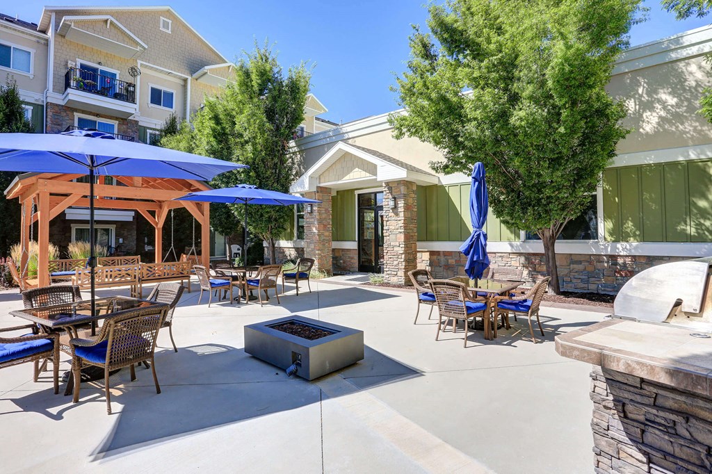 a patio with tables and umbrellas and a fire pit a patio with tables and umbrellas and a fire pit The Beckstead, South Jordan, UT, 84095