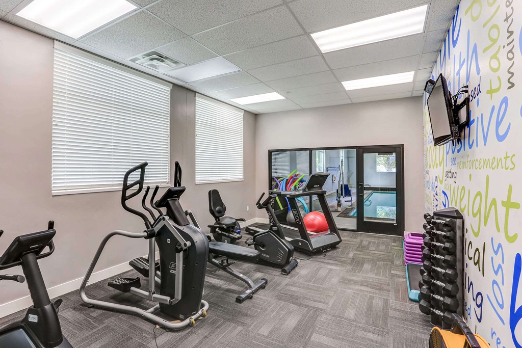 a gym with treadmills and other exercise equipment a gym with treadmills and other exercise equipment at The Beckstead, South Jordan, 84095