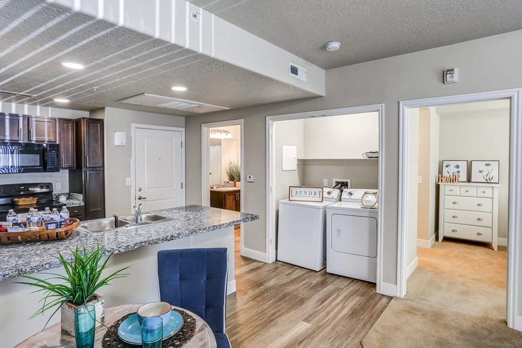 a kitchen and dining area in a 555 waverly unit a kitchen and dining area in a 555 waverly unit at The Beckstead, South Jordan, Utah