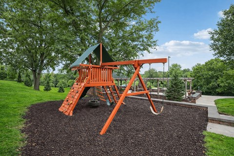 A playground with a swing set and a green roof at Aster Meadow, Vadnais Heights, MN, 55127