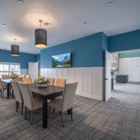 Community dining room with pendant lighting at The Hendrickson Apartments, Falcon Heights, Minnesota