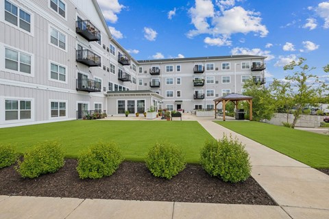 Courtyard with lawn and walkway to outdoor pavilion at The Hendrickson Apartments, Minnesota, 55113