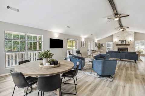 A modern living room with a round table and chairs.