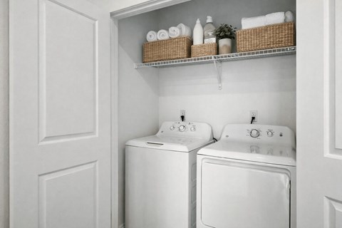 Inunit laundry room with storage shelf at Summit Ridge Townhomes Apartments, Reno, NV 89523