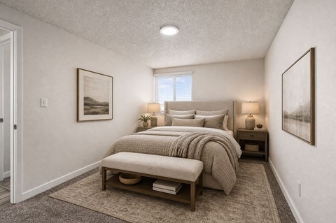 Bedroom with upholstered bed and neutral decor at Park Station Apartments, Midvale