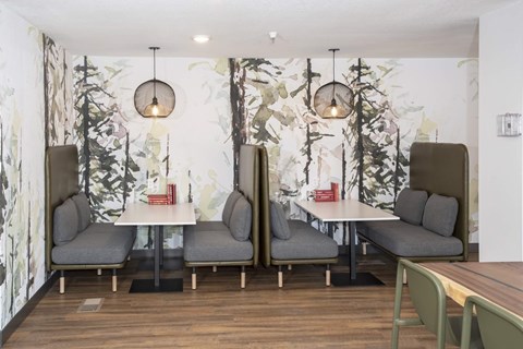 Private dining booths with forest mural wallpaper at Regency Park Apartments, St Cloud, MN