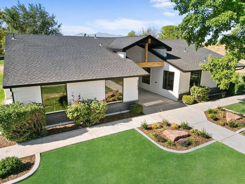 A modern house with a large front yard and landscaping at Lexington Park Apartments, Utah  