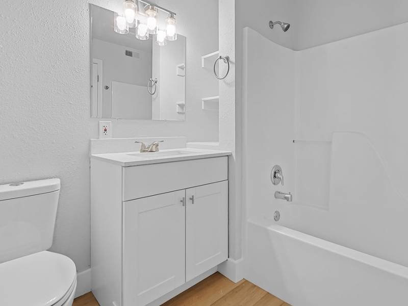 white bathroom with a toilet at Lexington Park Apartments, West Valley City, 84119