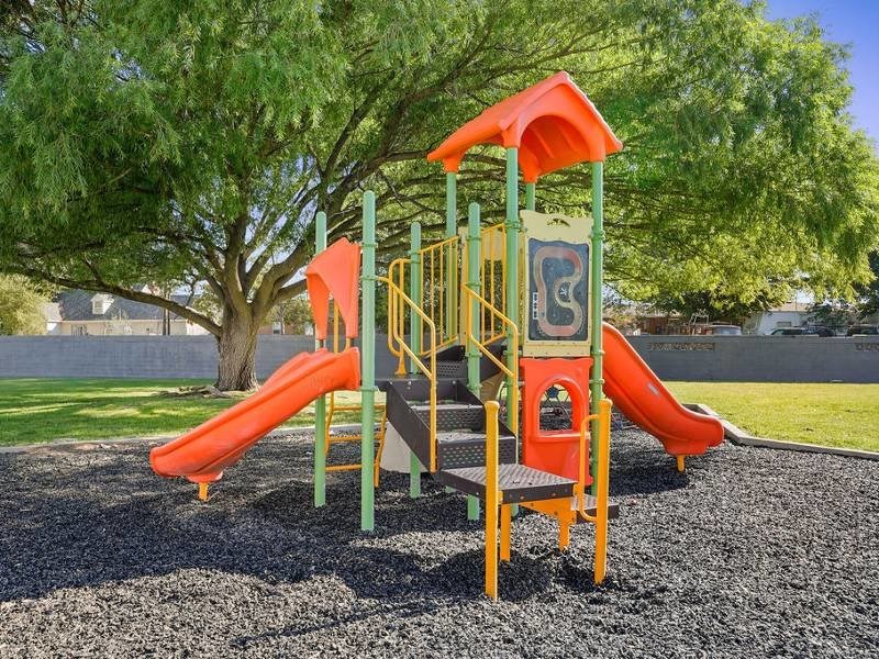 A playground with a red slide at Lexington Park Apartments, West Valley City