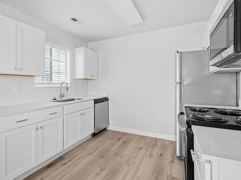 Kitchen with black appliances at Lexington Park Apartments, Utah, 84119