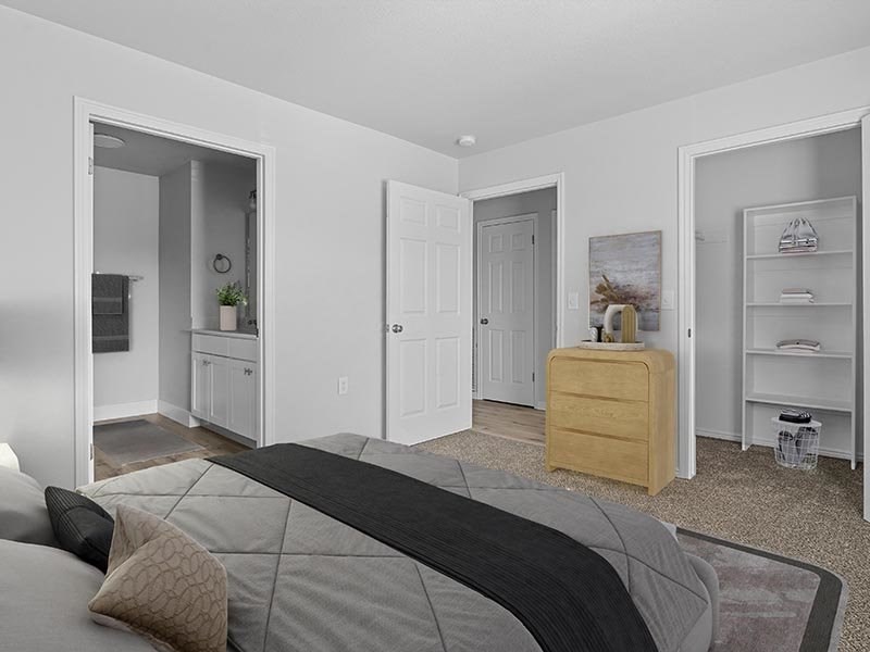 A bedroom with a bed, dresser, and shelves at Lexington Park Apartments, West Valley City, UT 84119 
