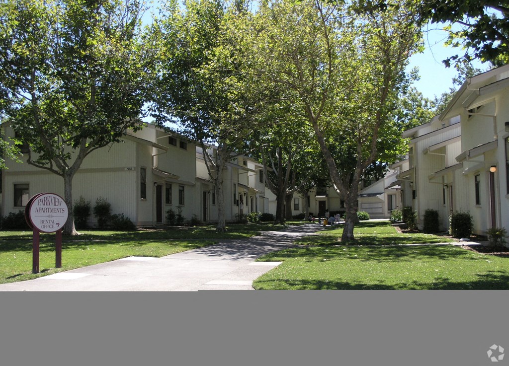a row of houses with trees in front of them