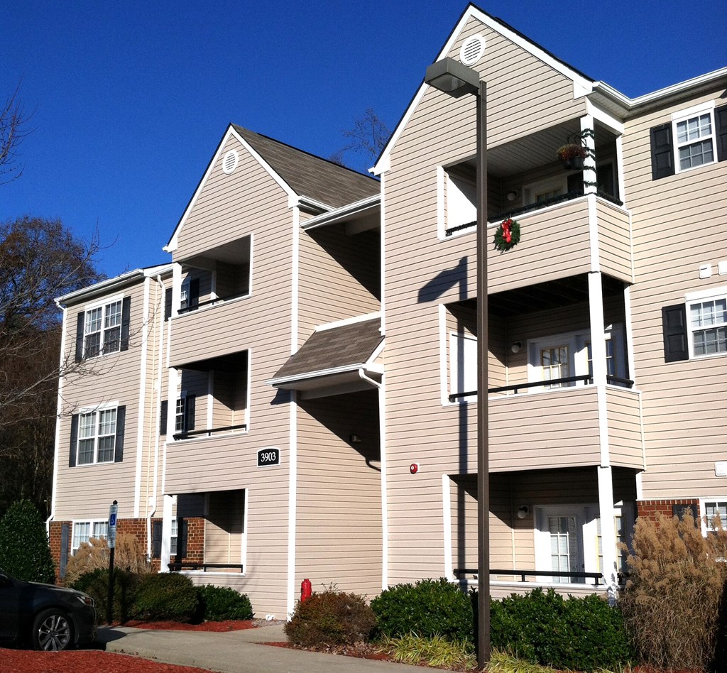 an apartment building with a street light in front of it