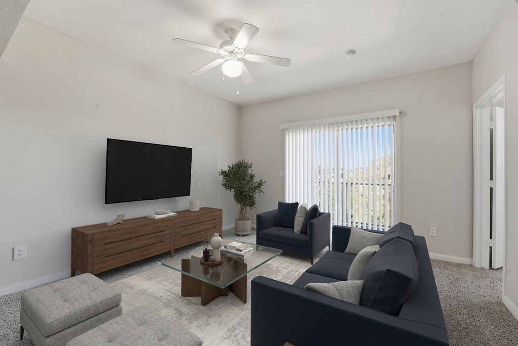 A living room with a flat screen TV mounted on the wall.