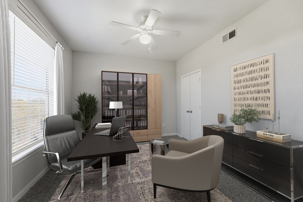 A modern office room with a desk, chair, and a ceiling fan.