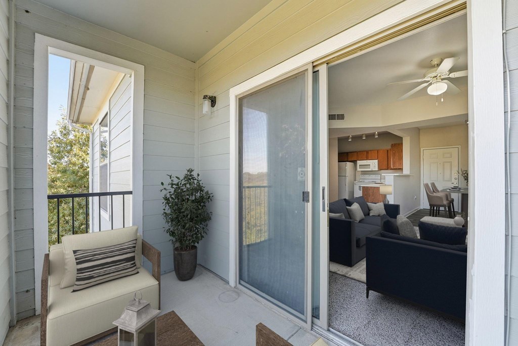 A balcony with a chair and a table.
