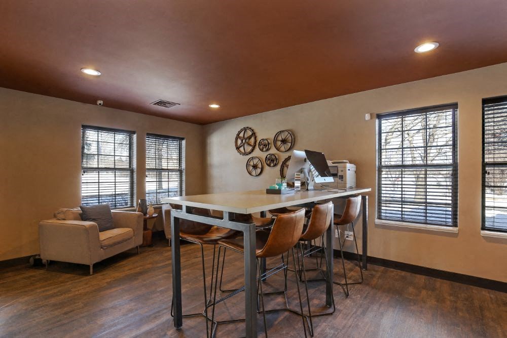 a kitchen with a bar table and chairs