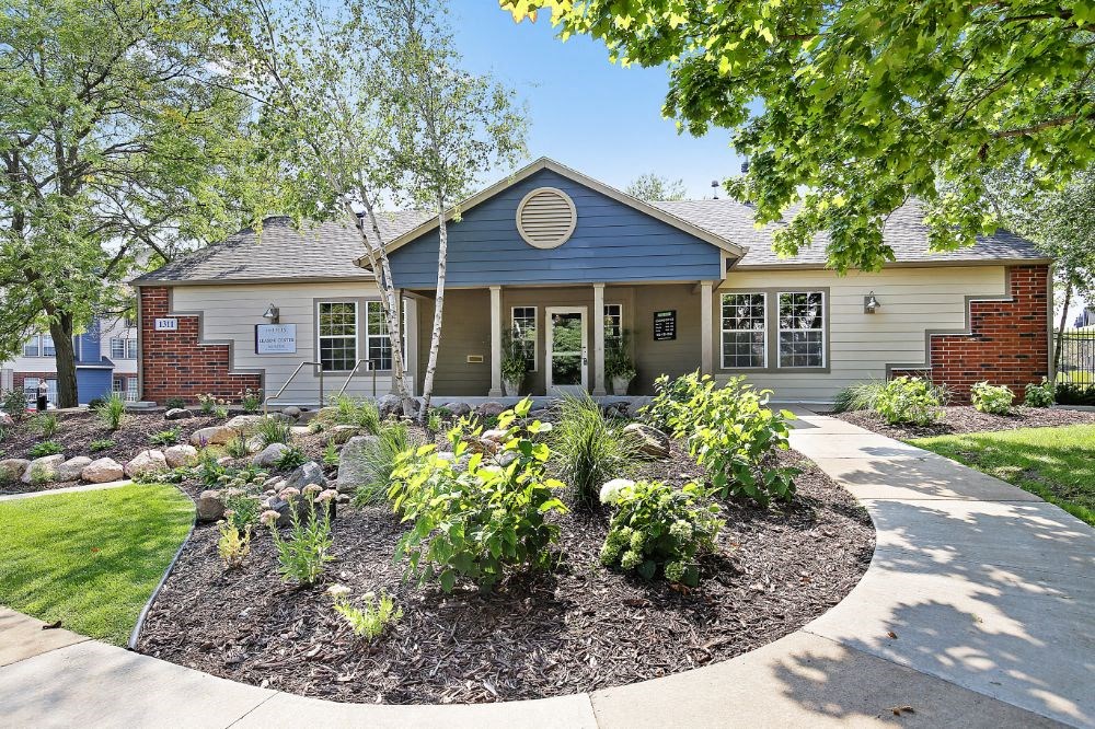 the front of a house with a garden in front of it