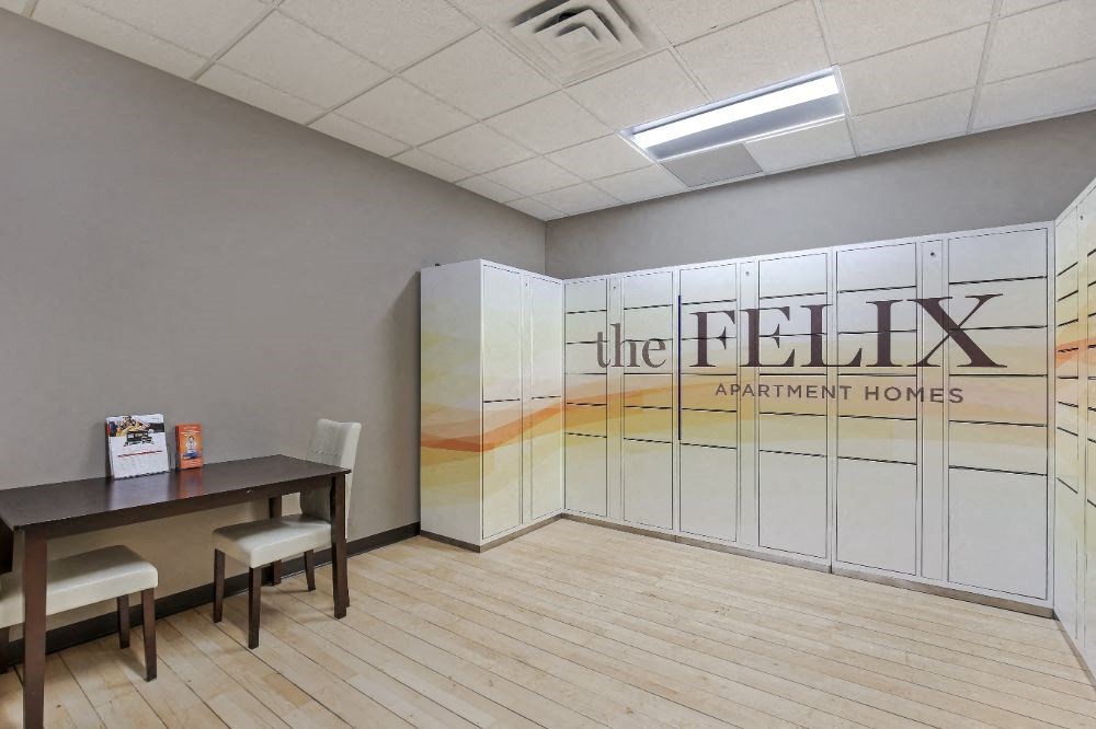 a room with white lockers and a table with chairs