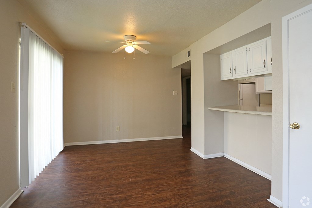 an empty living room with a ceiling fan at The Wilshire, Lake Charles