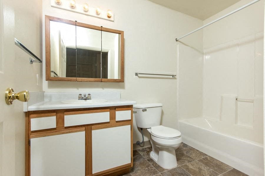 a bathroom with a toilet and a sink and a shower