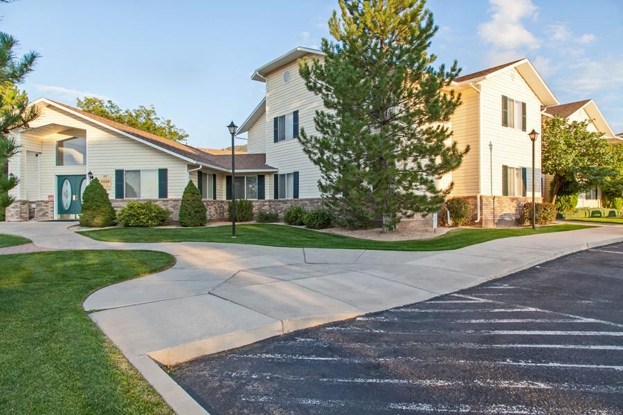a white house with a sidewalk in front of it