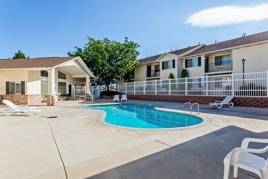 a swimming pool in front of a apartment building
