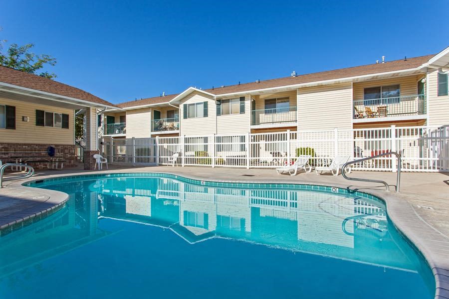 a large swimming pool in front of a building