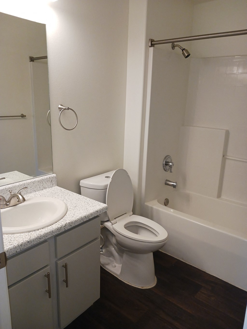 a bathroom with a toilet and a sink and a shower