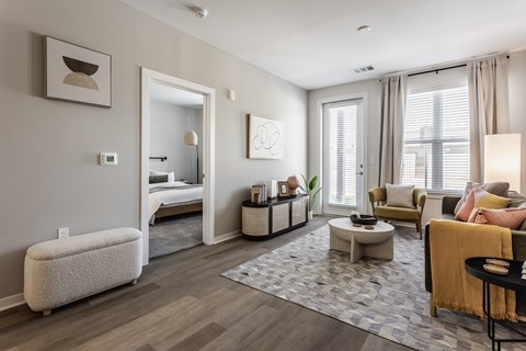 A modern living room with a grey carpet and a white sofa.