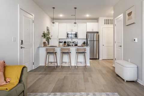 A kitchen with white cabinets and a refrigerator.