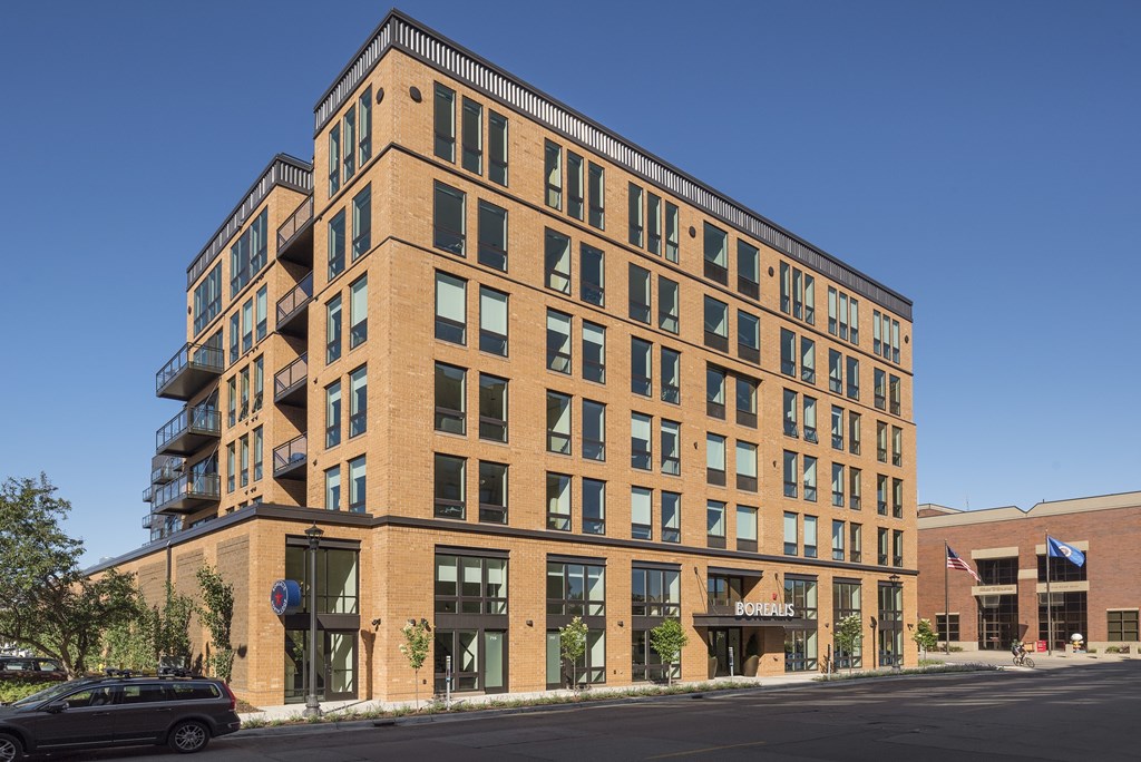 A large brick building with a balcony on the top floor.