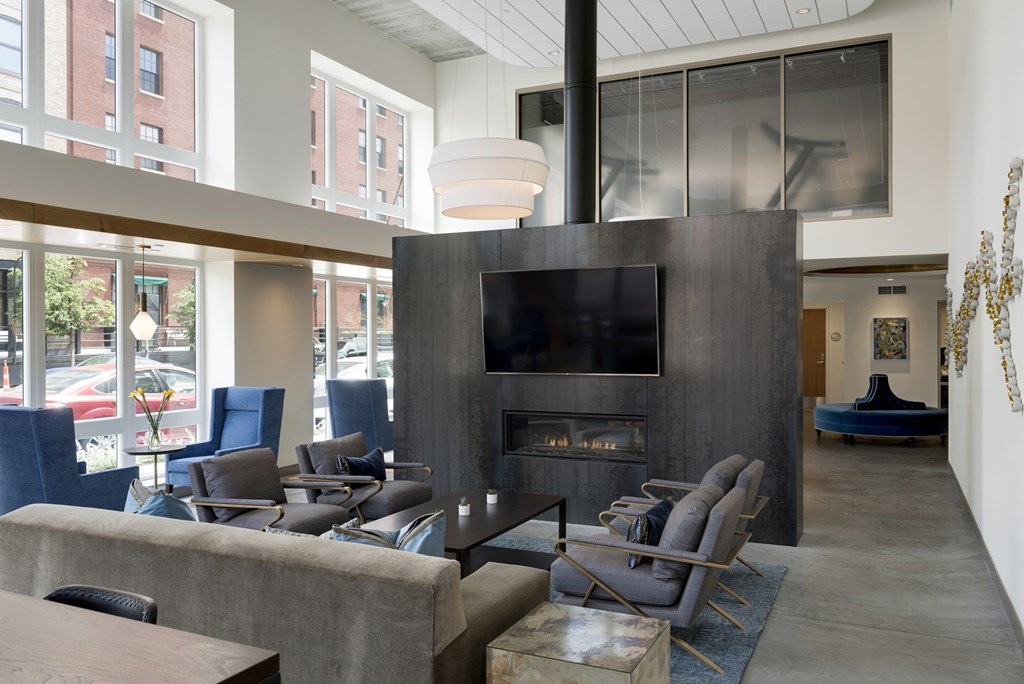 A modern living room with a fireplace and a television.