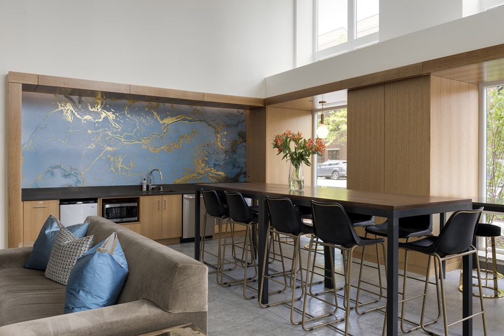 A modern kitchen with a blue and gold backsplash.