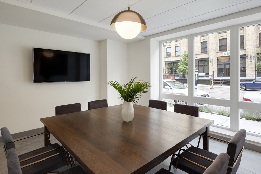 A conference room with a large table and chairs.