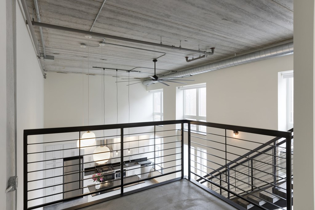 A large open space with a staircase and a balcony.
