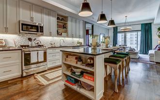Custom Model Kitchen with Dine-In Gourmet Kitchen Islands, Stainless Steel Appliances, and Gas Ranges Stoves