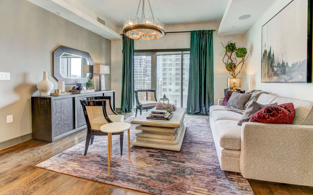 Model Living Room with Hardwood Style Flooring, Solar Shades, and Natural Lighting