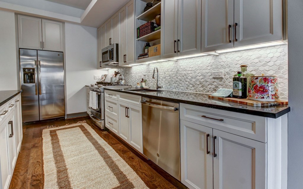 Modern Kitchen with Stainless Steel Appliances and Gas Ranges in Each Residence