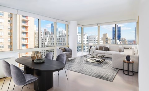 A modern living room with a large table and chairs.