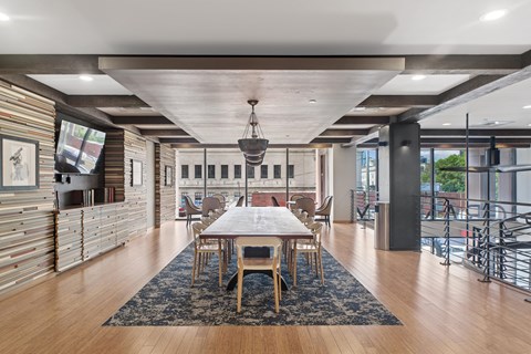 A modern dining room with a wooden table and chairs.