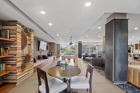 A modern living room with a dining table and chairs.