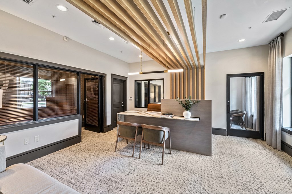 a conference room with a desk and chairs and a large window  at Park and Kingston, Charlotte, North Carolina