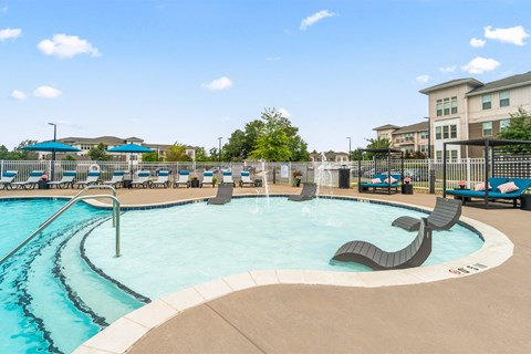 resort style pool with lounge chairs on in-water ledge at Sycamore at Tyvola, Charlotte