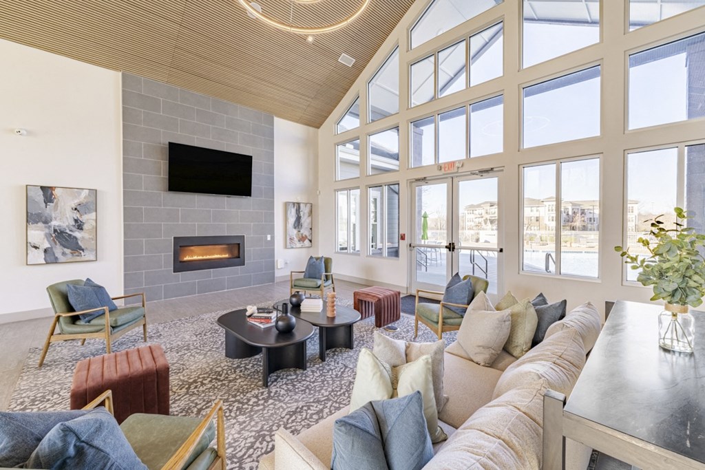 Community room with couches and chairs and fireplace at Sycamore at Tyvola, Charlotte, NC