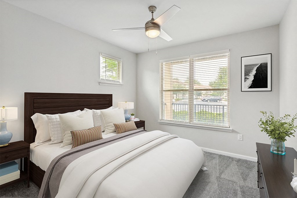 a bedroom with a large bed and two windows a bedroom with a large bed and two windows at Two Addison Place Apartments , Georgia