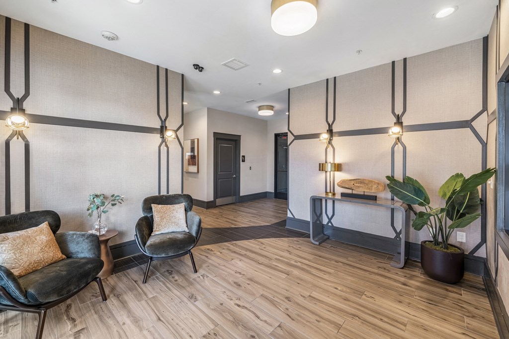 a lobby with chairs and a table with a plant  at Park and Kingston, Charlotte