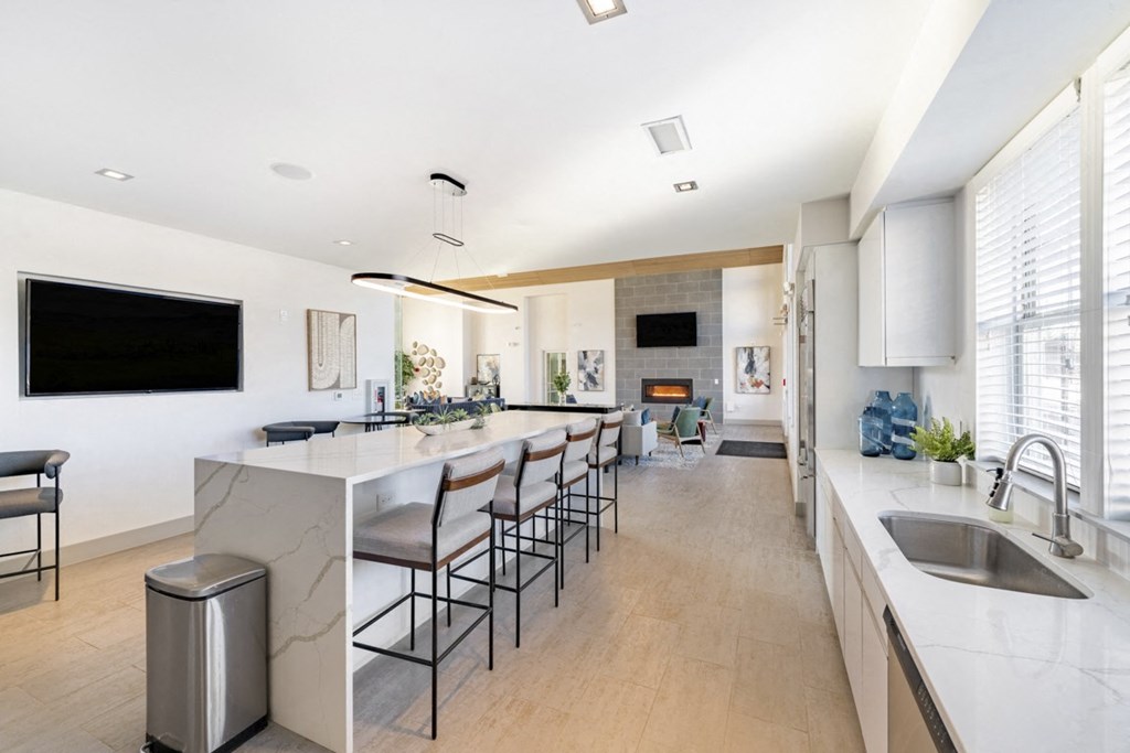 Community room kitchen with island and barstools at Sycamore at Tyvola, North Carolina